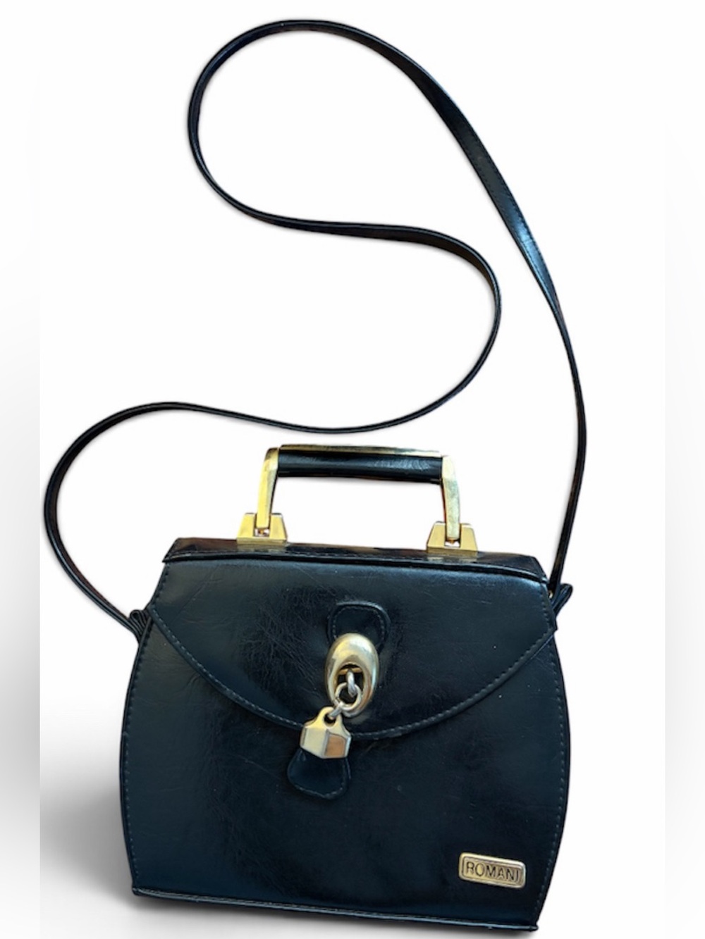 1960’s  black handbag featuring a structured top handle and gold-tone hardware